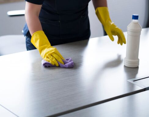 PCT Janitorial - professional cleaner polishing office table surface PCT Janitorial - professional cleaner polishing office table surface