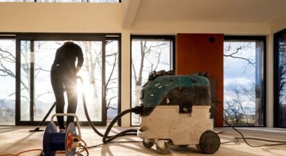 PCT Janitorial - Professional cleaning staff vacuuming spacious office interior