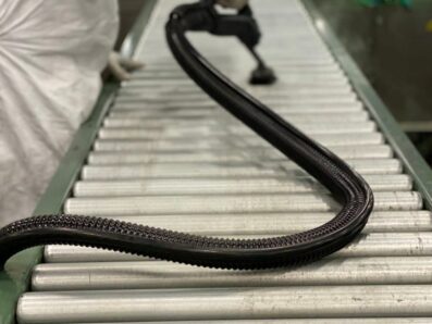 PCT Janitorial - Professional cleaner vacuuming conveyor belt in industrial facility. PCT Janitorial - Professional cleaner vacuuming conveyor belt in industrial facility.