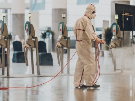 Professional disinfection service Person Wearing PPE Suit and Sanitizing Surroundings
