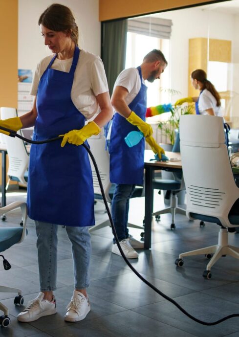 professional-cleaning-service-person-using-vacuum-cleaner-office